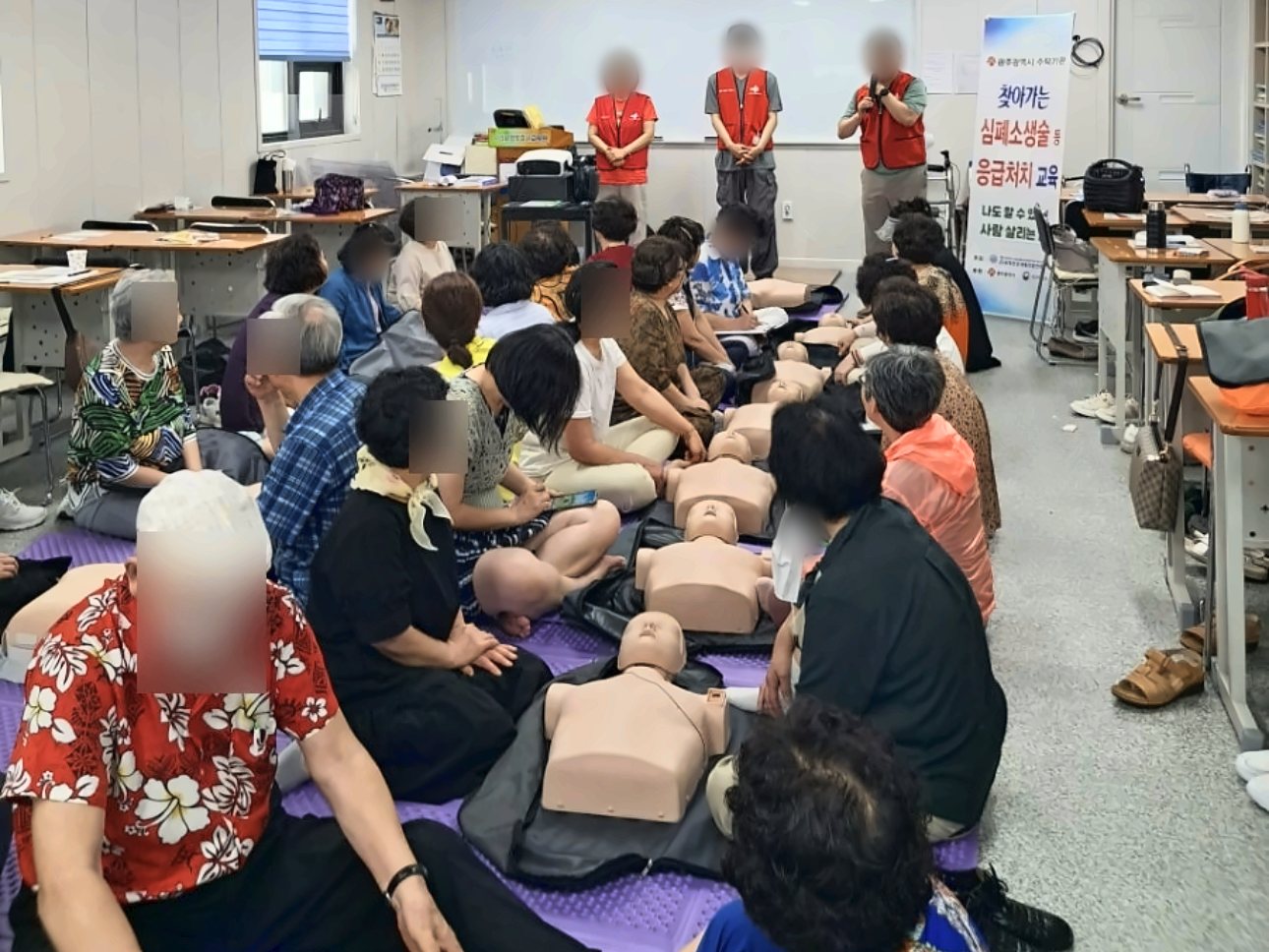 실습용 인형을 놓고 심폐소생술을 배우는 실기 수업